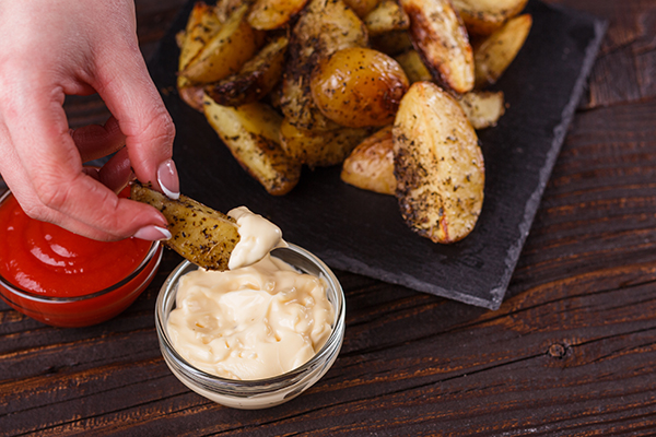 young-woman-dip-fried-potatoes-to-mayonnaise-sauce-2021-09-02-07-08-34-utc